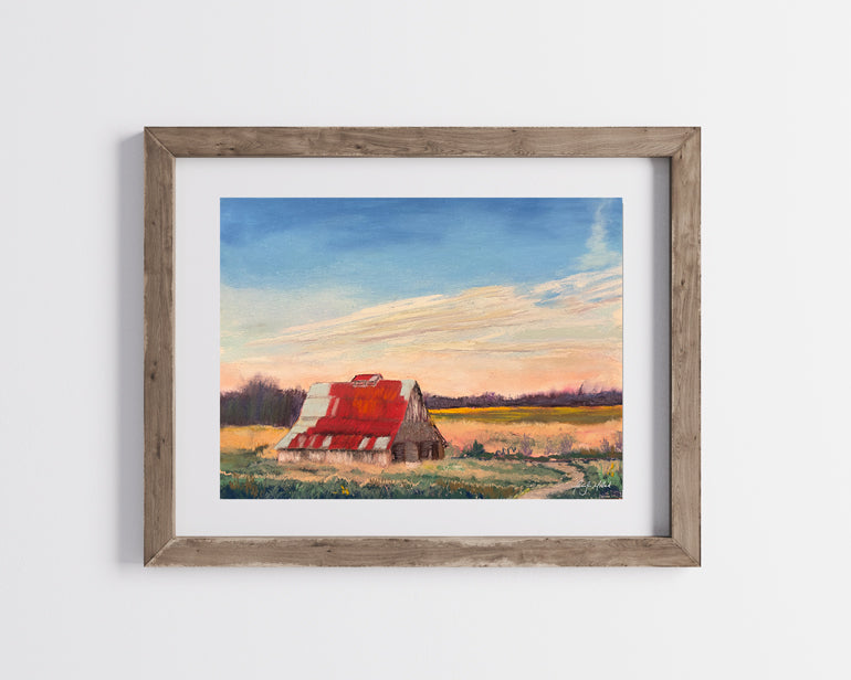 The giclee print of Battlefield Park's barn in a wood frame with a white mat.