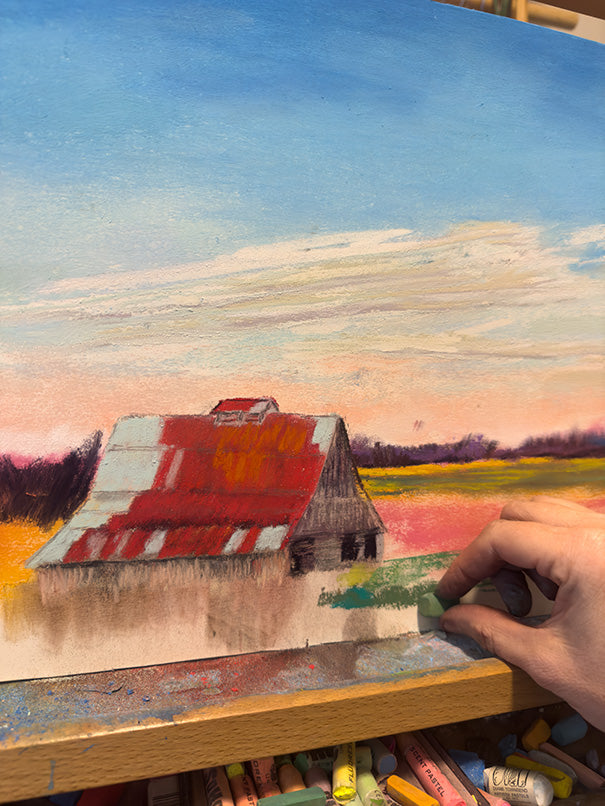 A photo of the artist, Jennifer Millard, working on the painting of the barn at Battlefield Park in Richmond, Kentucky.