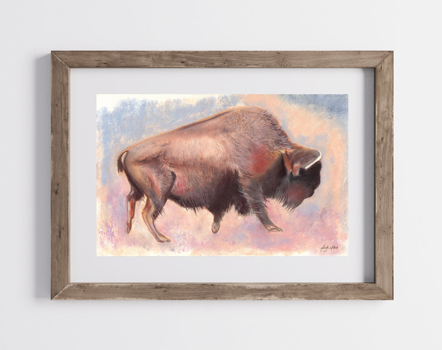 A photo of the bison print framed between glass pieces in a wood frame.