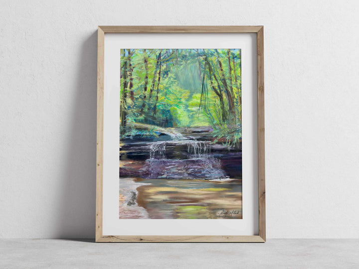 The museum quality print of Creation Falls in a white mat and natural wood frame.