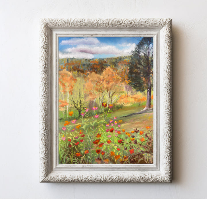 A photo of this print of colorful fall flowers in a white frame.