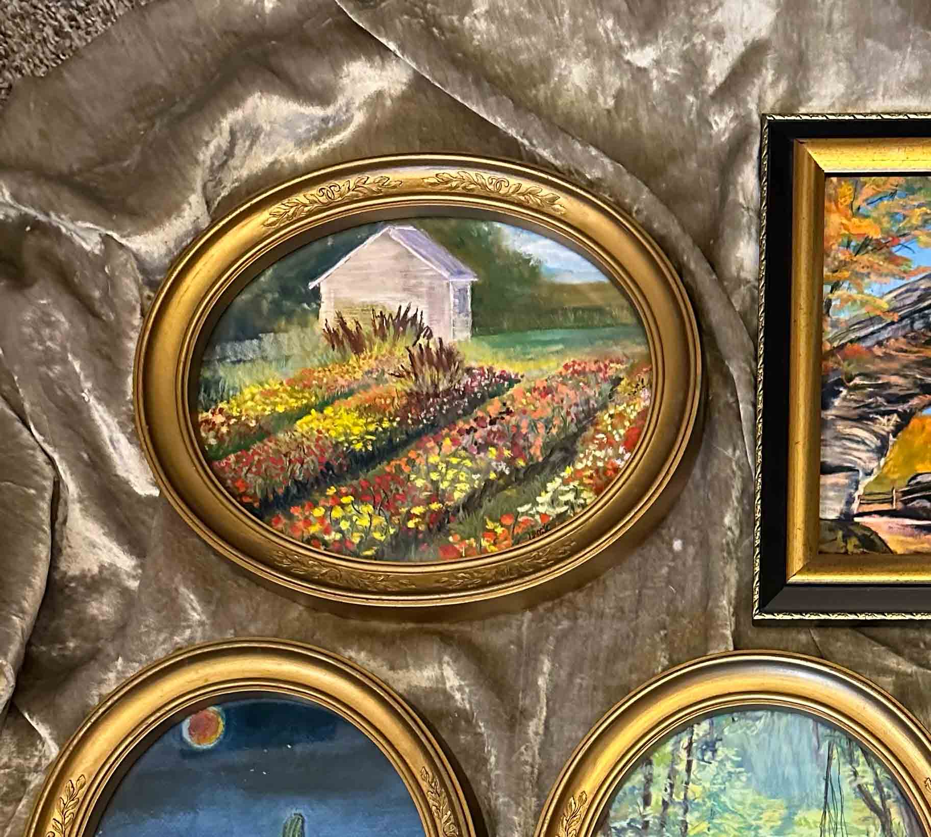 This colorful painting of bright flowers from a Kentucky flower farm is displayed in this pretty vintage oval frame.