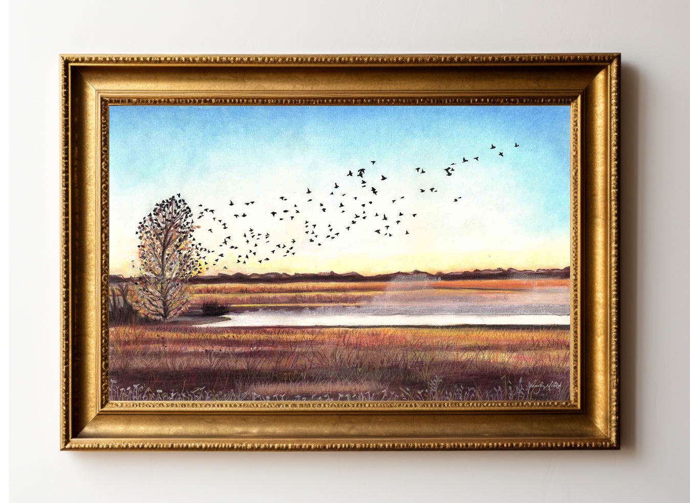 Giclee print in a gold frame of "Morning Rising" with birds lifting off from a tree and flying over water with mist rising from it.