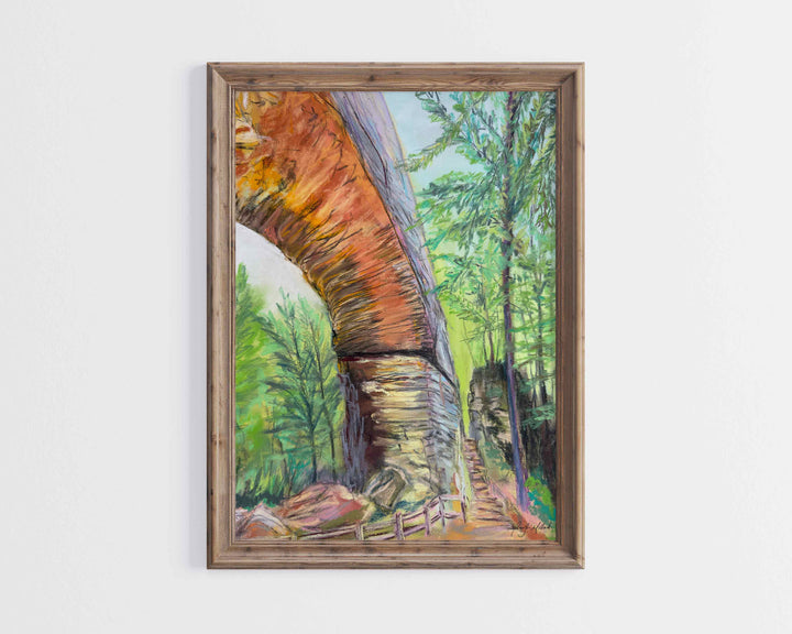 A giclee print of Natural Bridge and Fat Man's Squeeze is displayed in a light  brown wood frame.