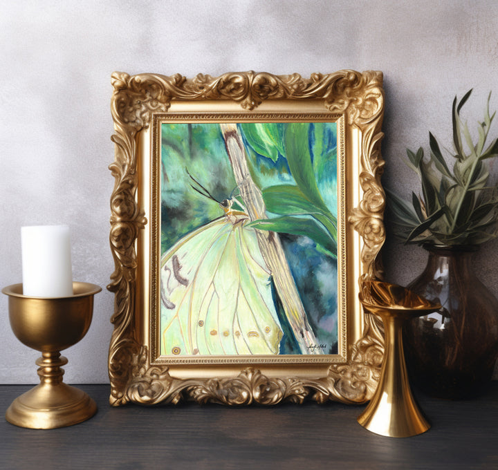 A giclee soft pastel print of a yellow green butterfly with a green blue background in a gold frame.