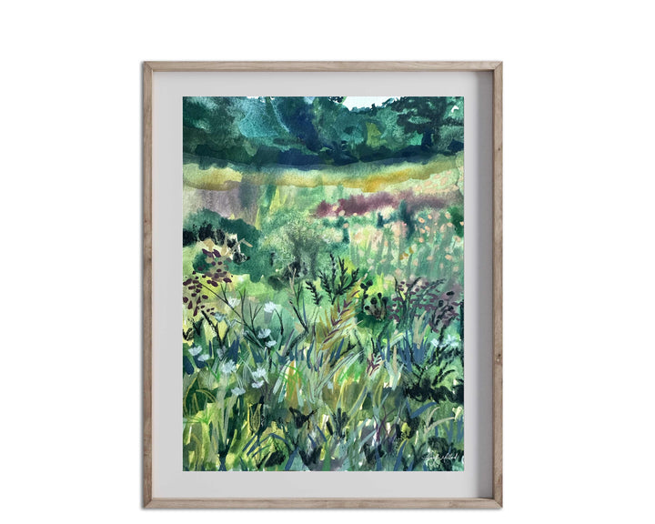 An abstract green meadow print in a light colored wood frame with a white mat.