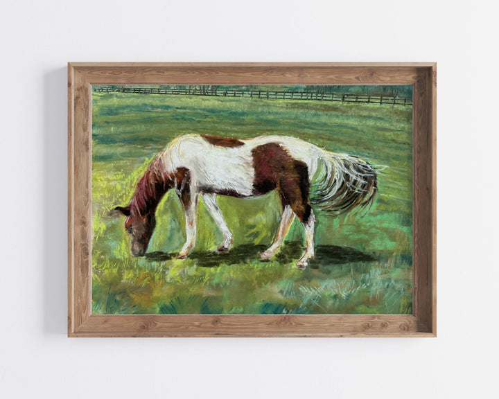 A fine art print of a horse in the spring in a wood frame.